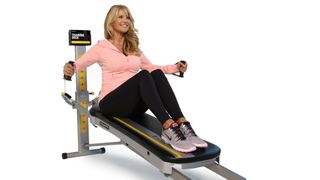 Total Gym FIT review: A woman uses the machine to work out her legs