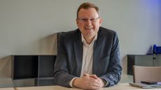 Dr Michael Berger, CEO of German SaaS company, DocuWare, pictured sitting at a desk.