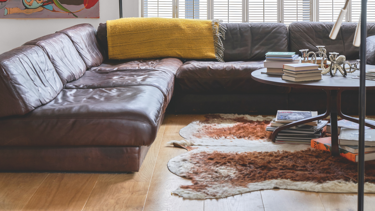 iving room with pale wood floor, animal skin rug and circular coffee table. Large picture on the wall in the background and french door with white shutters. Pub Orig Ground floor apartment in a mid century converted warehouse in South London, home of Mark Hix restaurant and hotel owner.