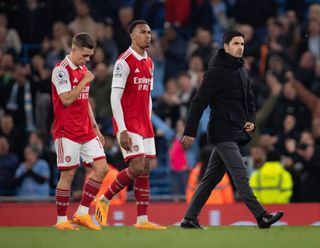 Arsenal manager Mikel Arteta walks off the pitch looking dejected followed by Leandro Trossard and Gabriel Magalhaes of Arsenal following the Premier League match between Manchester City and Arsenal FC at Etihad Stadium on April 26, 2023 in Manchester, United Kingdom.