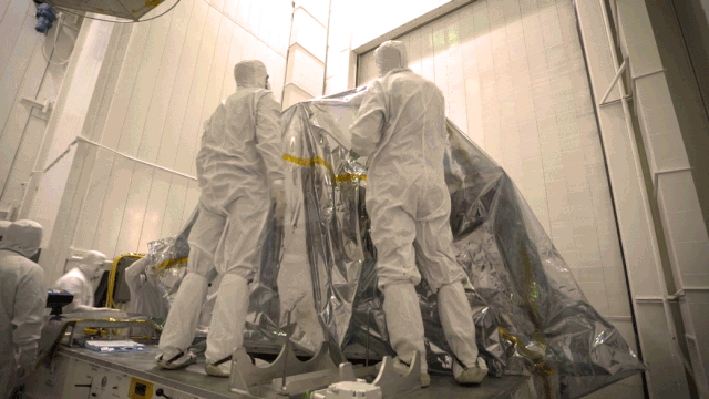 Engineers remove the inner layer of protective foil from NASA's Mars 2020 rover.