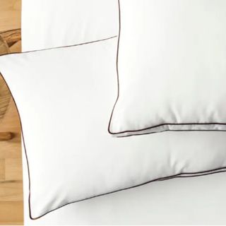 Two Saatva latex pillows on a white mattress