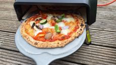 Pizza going in the Tefal Jamie Oliver by Tefal JM4168G1 Stone-bake Pizza Oven