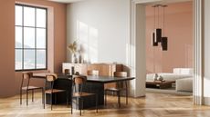 modern open dining room with wood flooring, white wall and terracotta accent walls