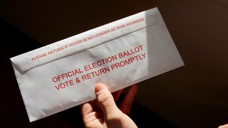 A person holding a mail-in ballot