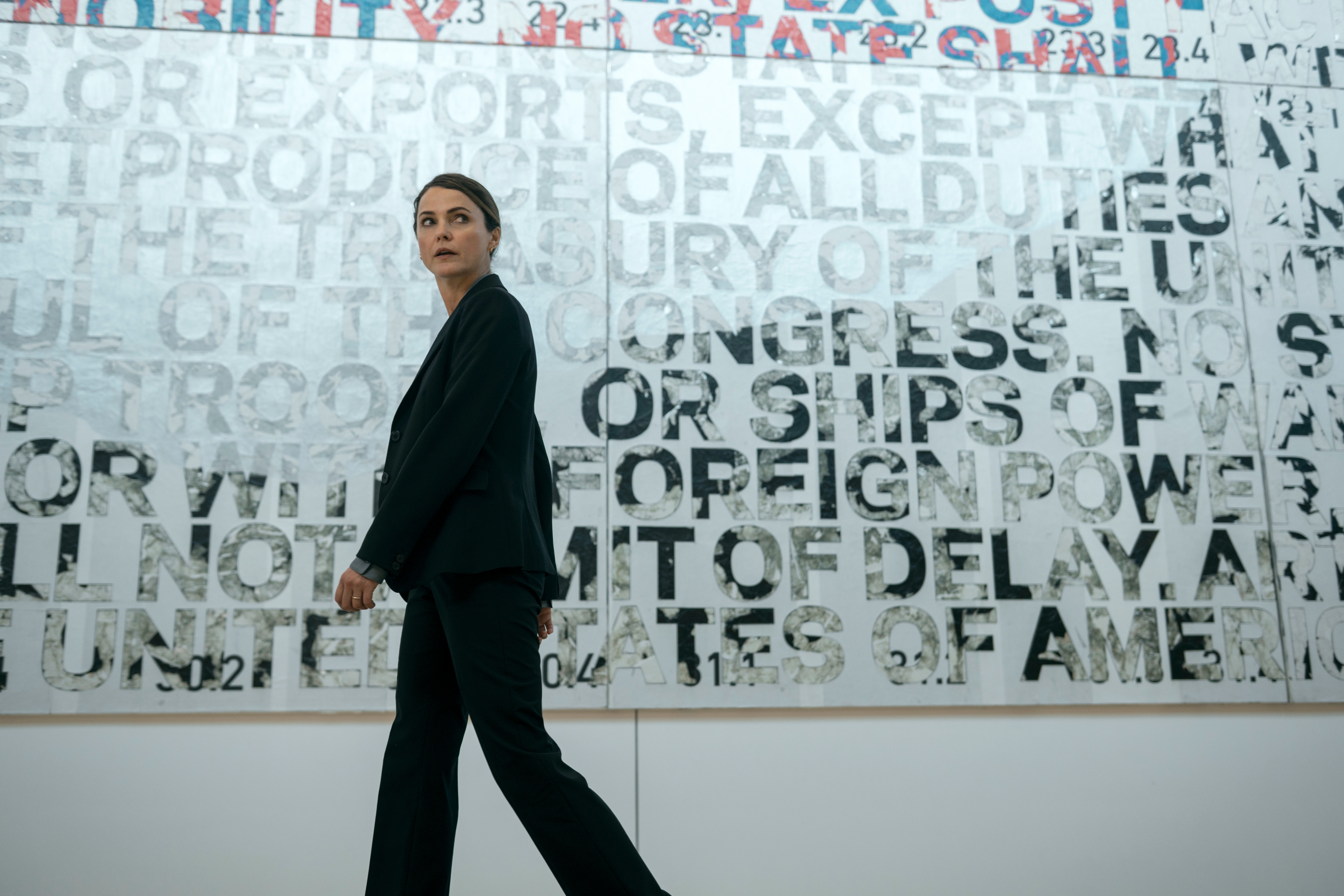 keri russell as kate wyler walking through a government building in the diplomat season 3