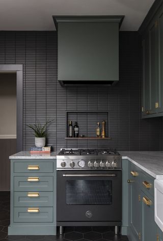 A kitchen with grey green cabinets