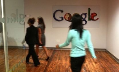 Employees walk down the hallway of the company's Chelsea Market office in New York City. Google has recently opened offices in Pittsburgh and Hong Kong. 