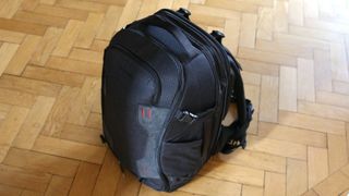 Manfrotto Pro Light Flexloader L, one of the best camera backpacks, on a wooden floor