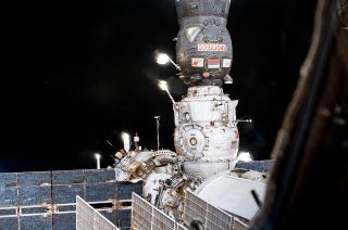 Russia’s Progress MS-16 cargo craft (at top) is pictured docked to the Pirs docking compartment on the International Space Station, prior to both craft departing the orbiting complex to make way for the Nauka multi-purpose laboratory module in July 2021.