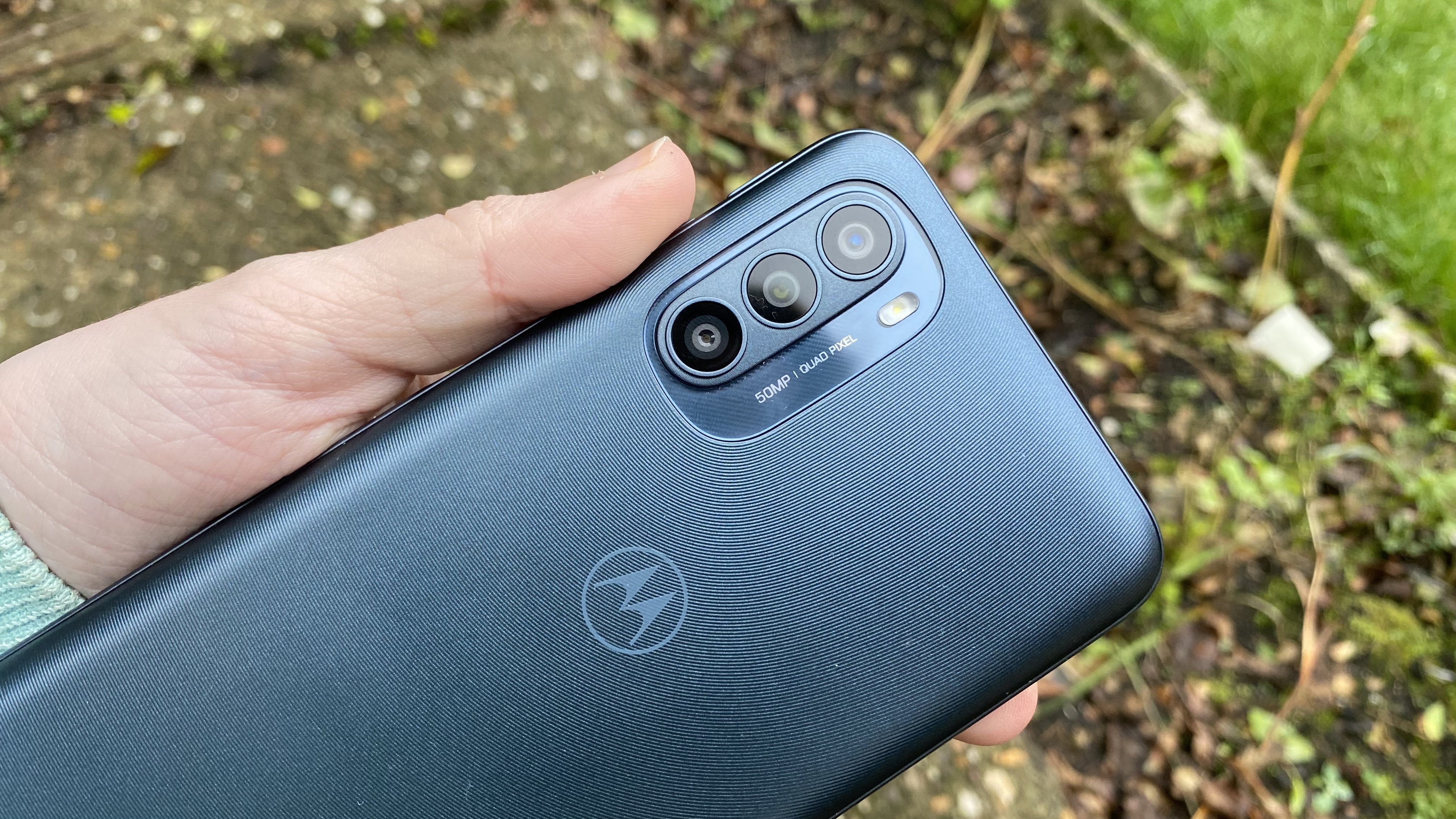 A Moto G31 from the back, in someone's hand
