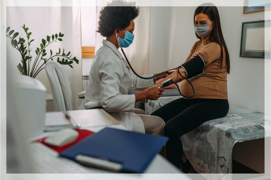 Pregnant woman being monitored by a doctor for pre-eclampsia symptoms and prevention