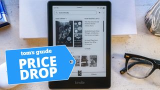 Kindle Paperwhite Signature Edition shown next to reading glasses and Beats earbuds