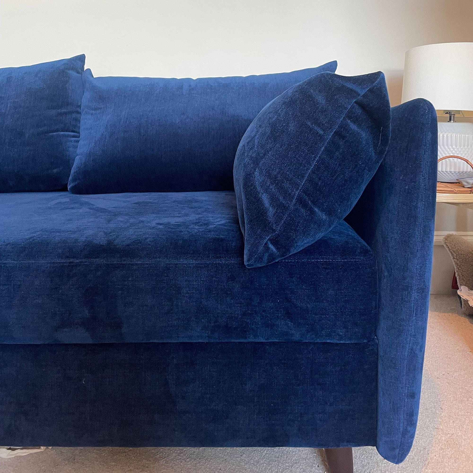Swyft model 08 two seater sofa bed in Indigo velvet in neutral living room