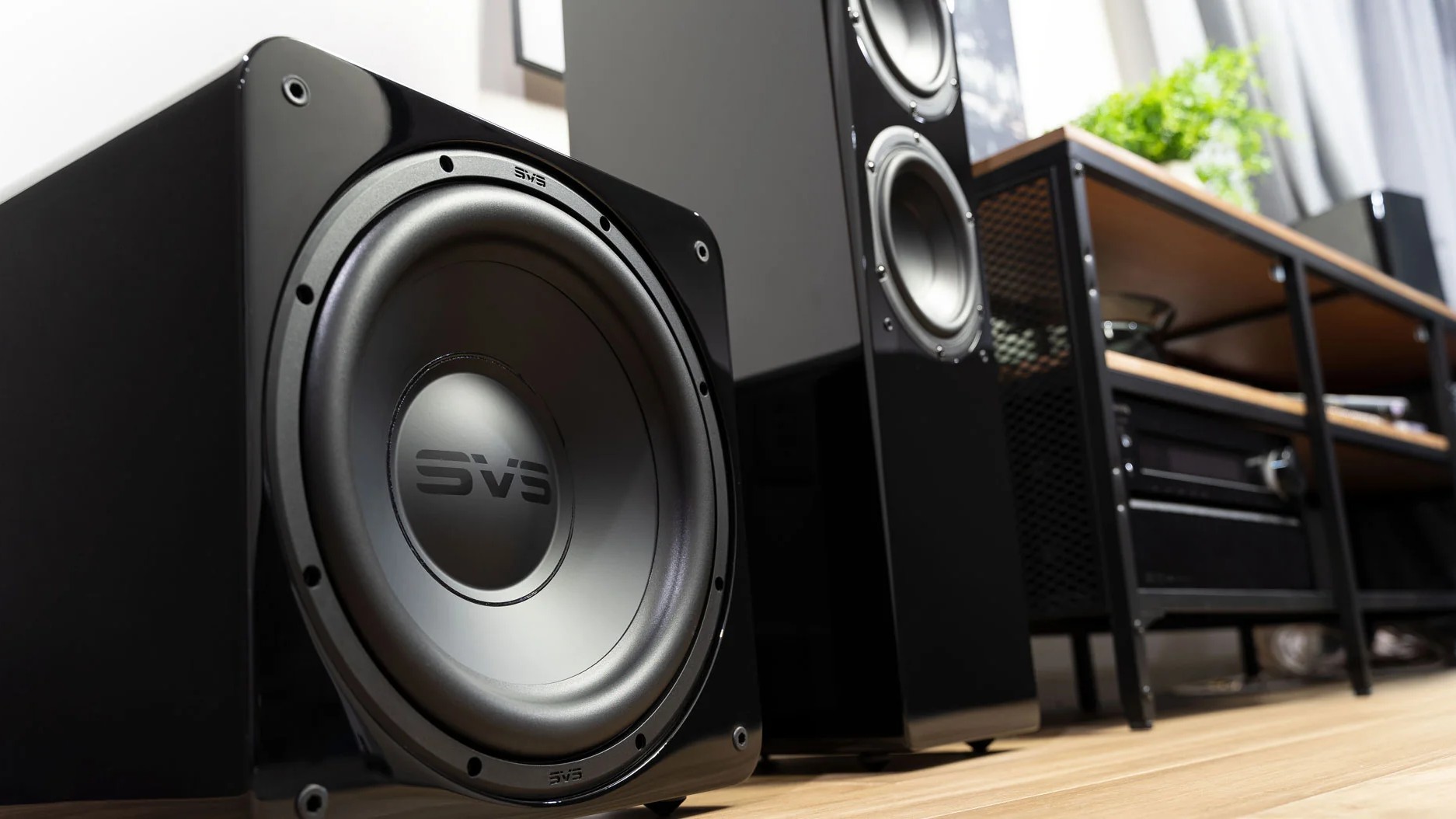 SVS subwoofer on floor next to tower speaker