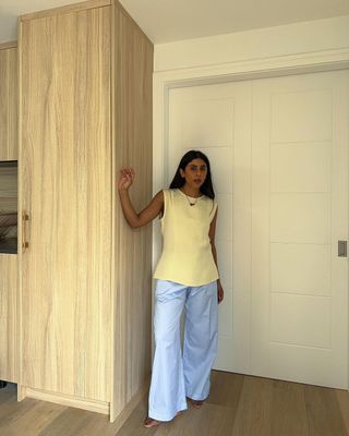 @monikh wearing butter yellow top and baby blue trousers