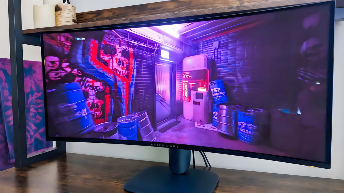 Alienware 34" Curved QD-OLED AW3425DW Gaming Monitor displaying a scene from Cyberpunk 2077 with vibrant purple lighting.
