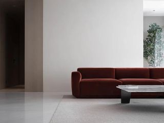 Minimalist living room with red sofa at red box house in China