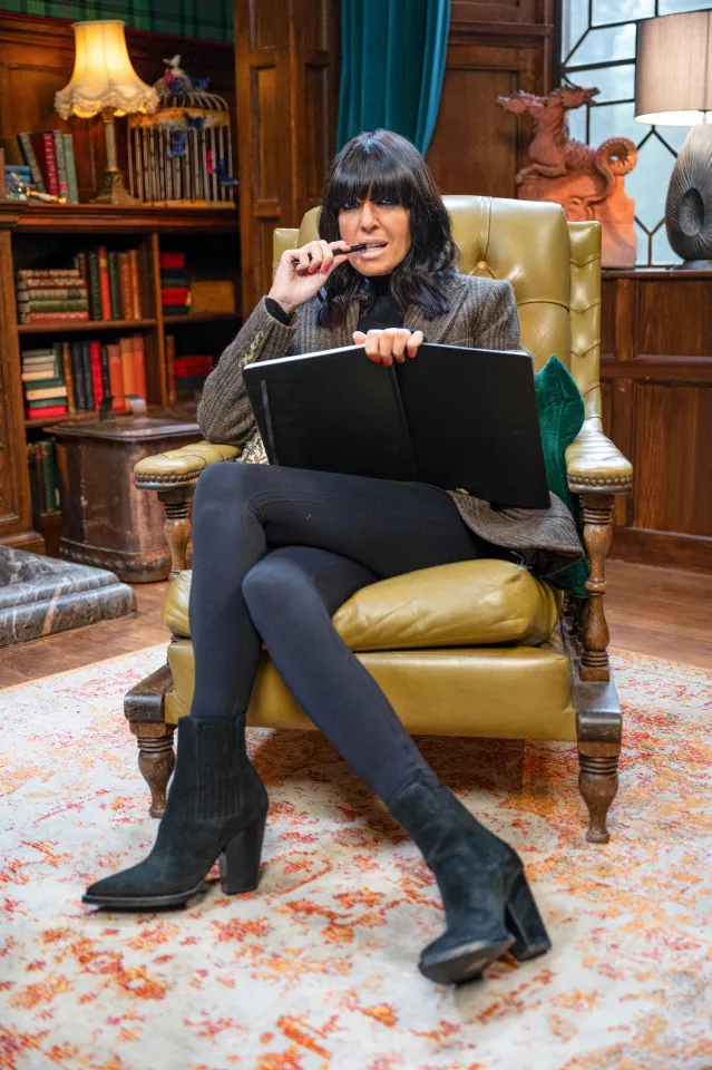 Claudia Winkleman wearing YSL boots on The Traitors