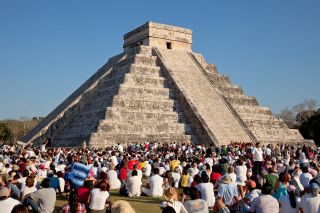 Tourists watching the feathered serpent crawling down the Temple of Kukulcan during the equinox on March 21, 2011 in Chichén Itzá, Mexico.