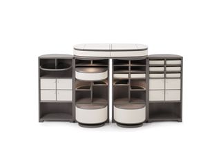 A large drinks cabinet with four compartments, each featuring shelves and drawings, in grey and white