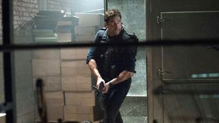 A still from the movie Olympus Has Fallen, showing Gerard Butler as secret service agent Mike Banning holding a gun