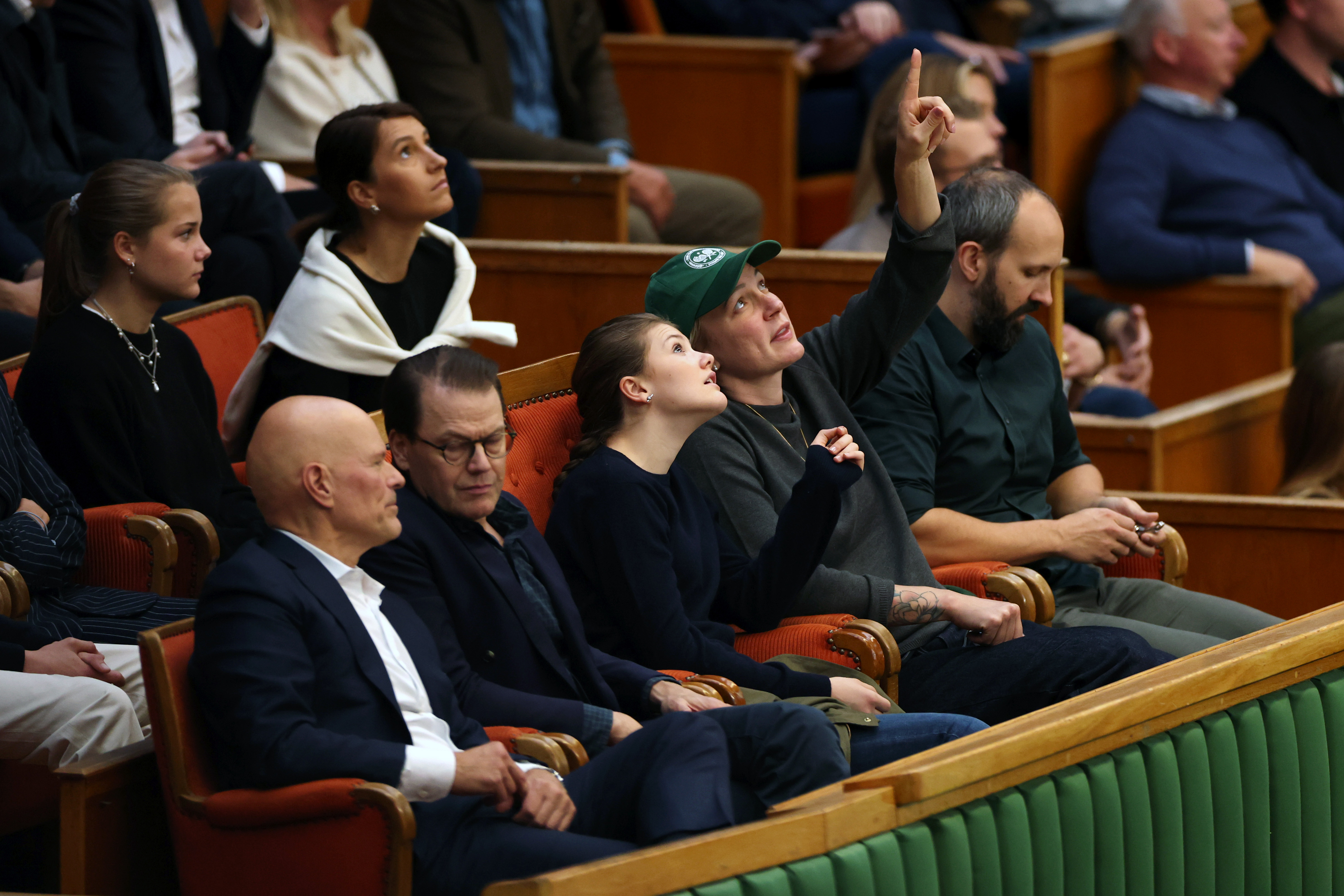 Princess Estelle of Sweden and Sarah Sjostrom, Swedish Olympic Swimmer, pointing at the ceiling at a tennis match