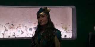 Salma Hayek looks up smiling, in full costume in Marvel's Eternals.