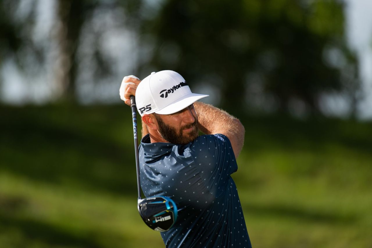 Photo of Dustin Johnson hitting a driver with LA Golf shaft