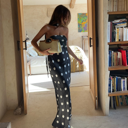 Cl&eacute;mence wearing polka dot dress and woven baguette bag