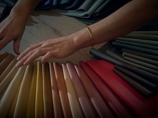 Hands touch Edelman Leather swatches