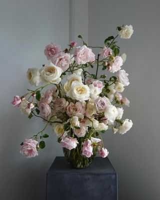 a fresh flower arrangement on a gray pedestal