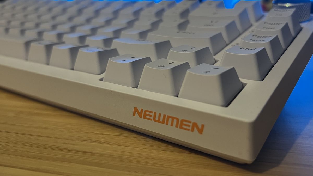 Front corner of Newmen GM326 gaming keyboard showing sides of keycaps