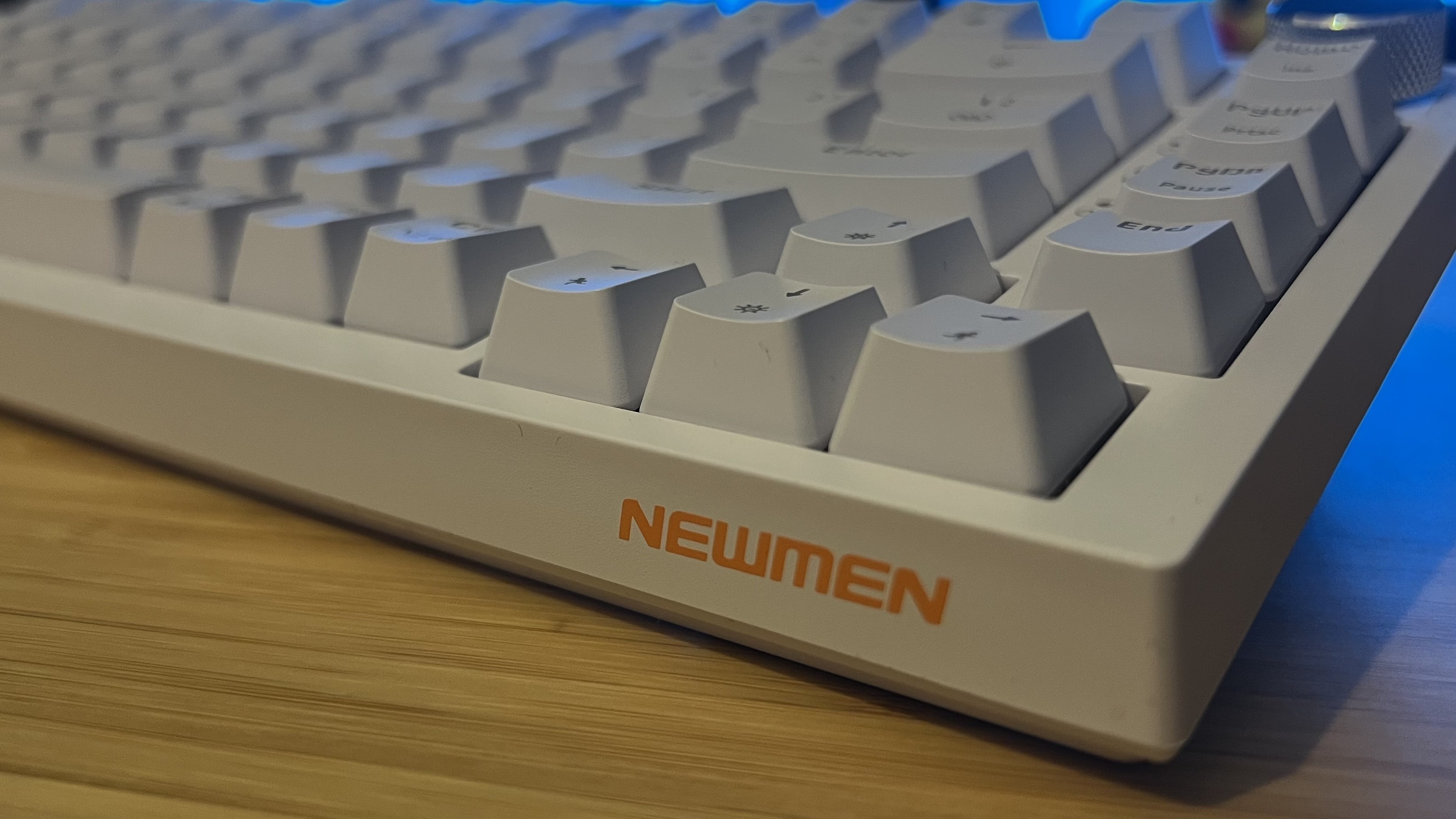 Front corner of Newmen GM326 gaming keyboard showing sides of keycaps