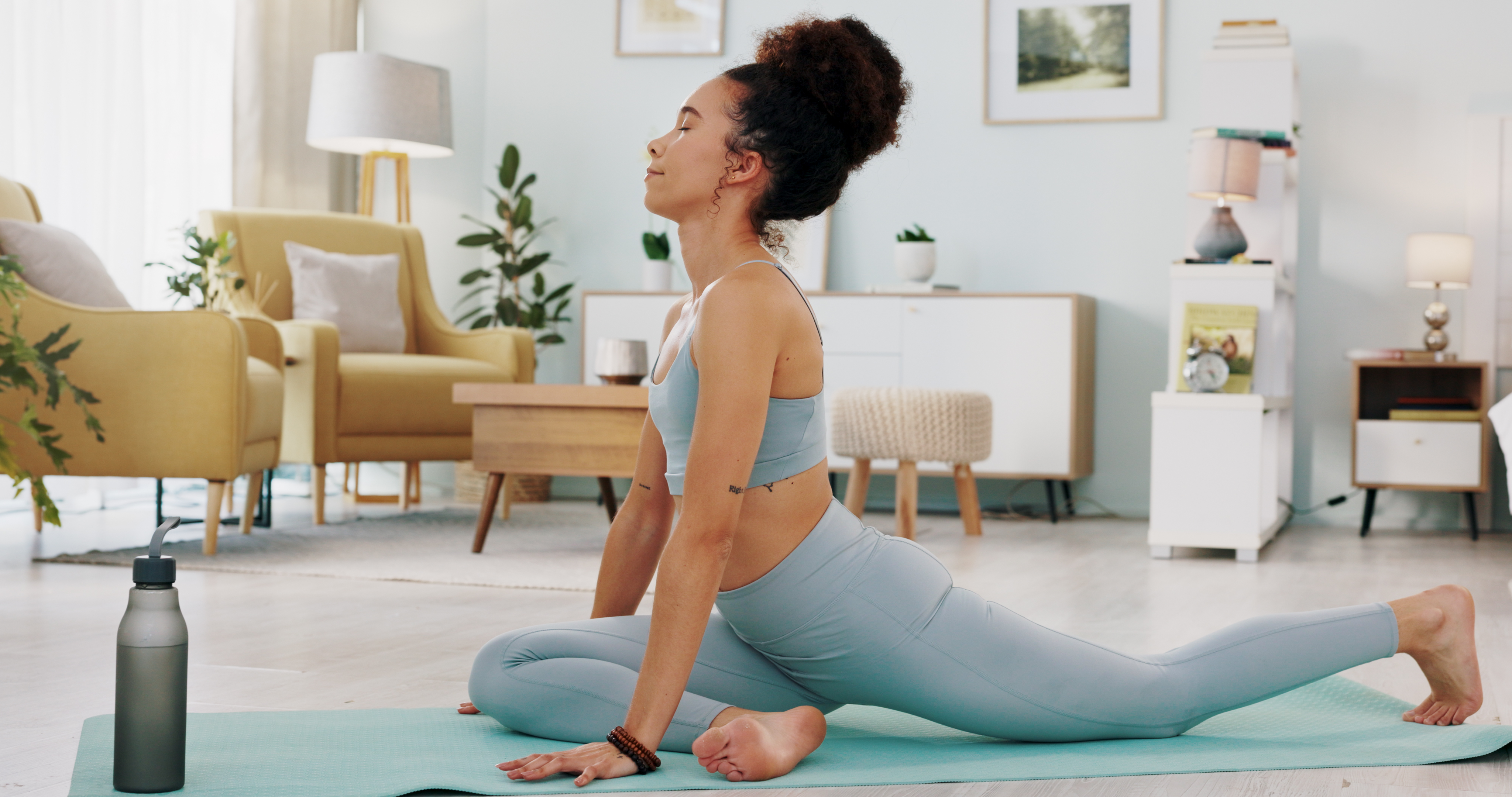 Woman in pigeon pose in domestic setting