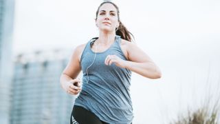 Woman jogging in grey tank top