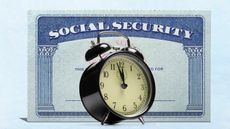 An alarm clock stands in front of a Social Security card.