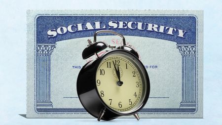 An alarm clock stands in front of a Social Security card.