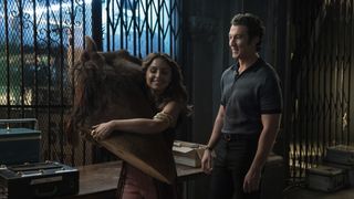 Aimee Carrero holding a fake horse head in The Offer, with Miles Teller