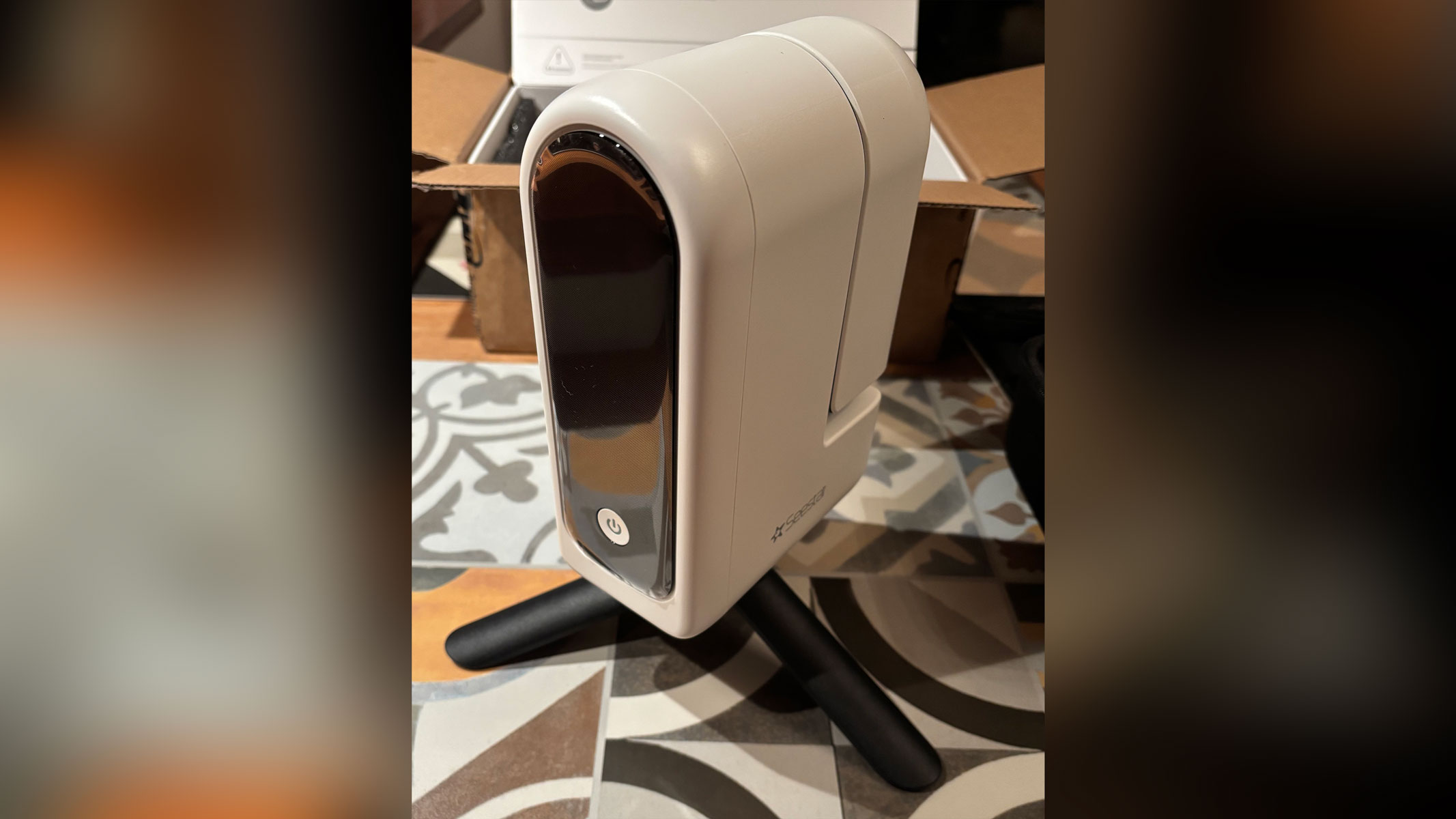 A white smart telescope stood on a tiled surface.