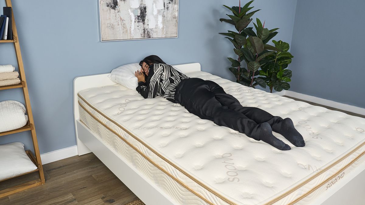 Eve, the Sleep Staff Writer at Tom's Guide, sleeps on her stomach during a pressure relief test for the Saatva Classic mattress review