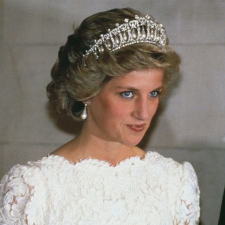 Princess Diana wearing a white evening dress and the Queen Mary tiara at a visit to the British Embassy in Washington with Prince Charles on November 11th, 1985