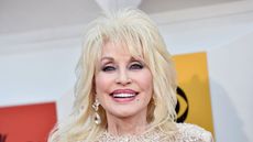 dolly parton on a white background with yellow and red signs