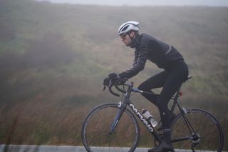 Image shows a rider cycling outdoors