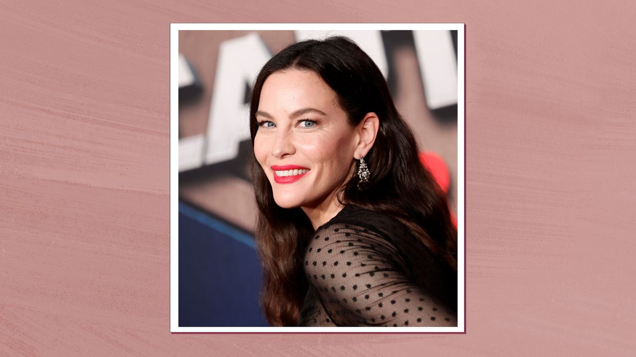 Liv Tyler is pictured wearing red lipstick and a black dress with mesh, polka dot sleeves at the World Premiere Of Marvel Studios&#039; &quot;Captain America: Brave New World&quot; at TCL Chinese Theatre on February 11, 2025 in Hollywood, California/ in a dark pink template