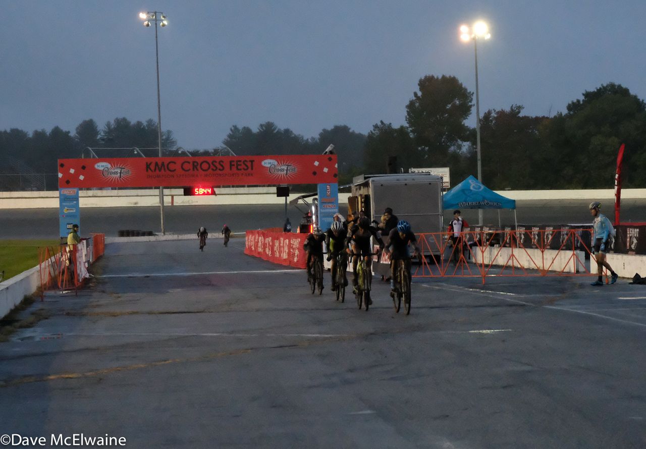 Riders pass through a deserted start/finish area with one lap to go