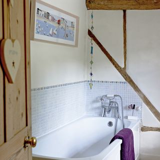 white bathroom with bathtub and mosaic tiles