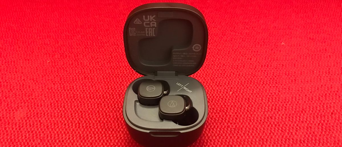 Audio-Technica ATH-SQ1TW earbuds and case on red background