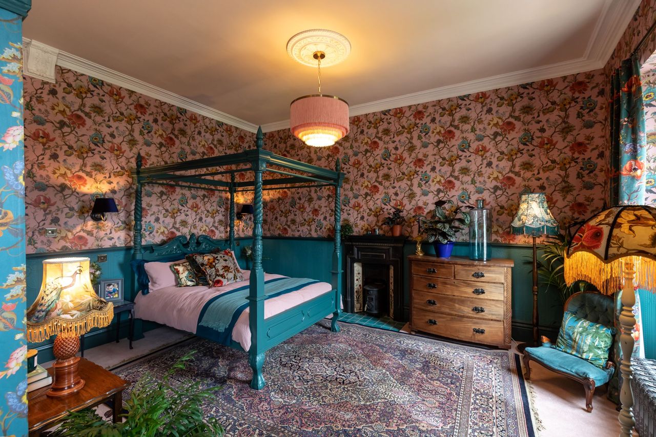 The period style bedroom has 4 bannisters and claret walls