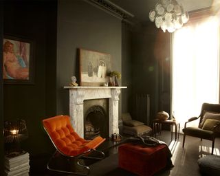Dark living room idea with fireplace by Renaissance London